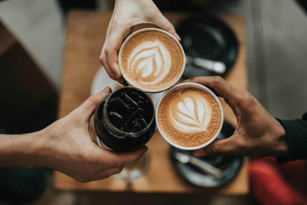 Does Coffee Increase Blood Sugar Levels? 16 three person holding beverage cups